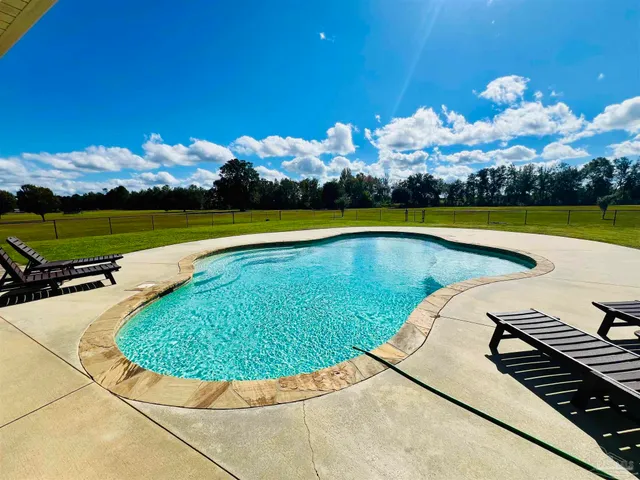 a view of a swimming pool with a chair