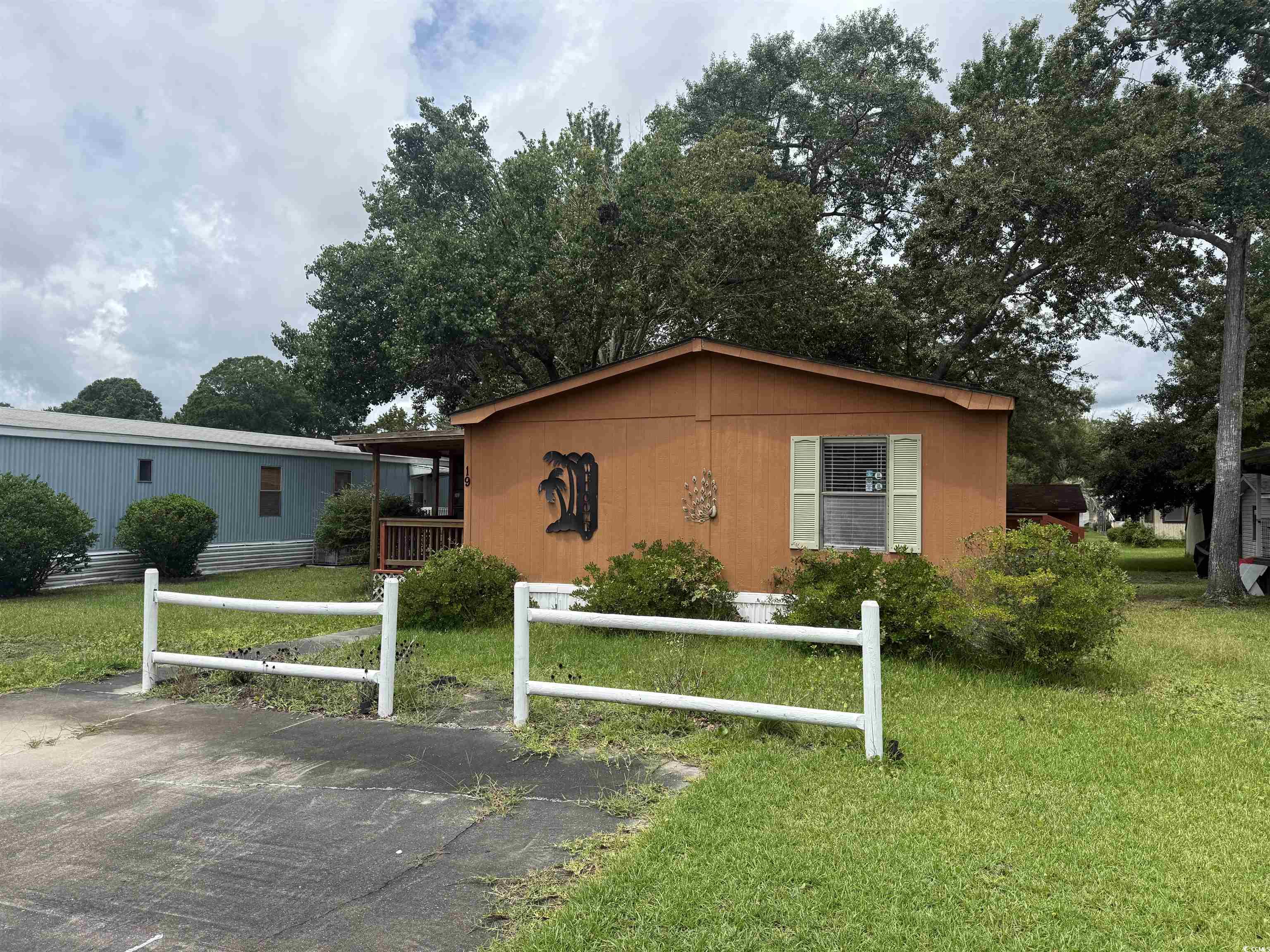 View of property exterior with a yard