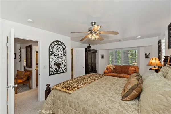 a bedroom with two beds and a chandelier