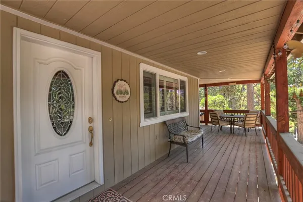 a view of a room with furniture wooden floor and windows