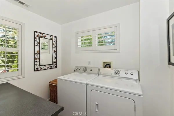 a bedroom with a bed and dresser with mirror