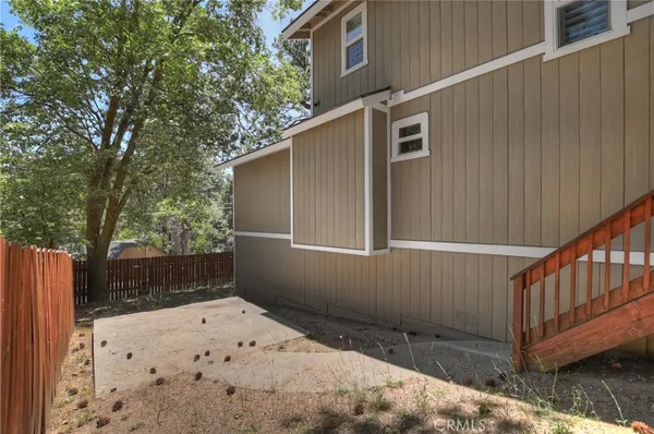 a backyard of a house with table and chairs