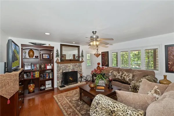 a living room with furniture a fireplace and a flat screen tv