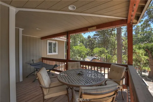 a view of balcony with chairs and wooden floor