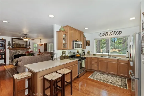 a kitchen with a sink and chairs