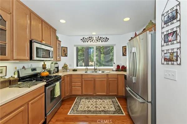 a kitchen with stainless steel appliances granite countertop a refrigerator and a sink