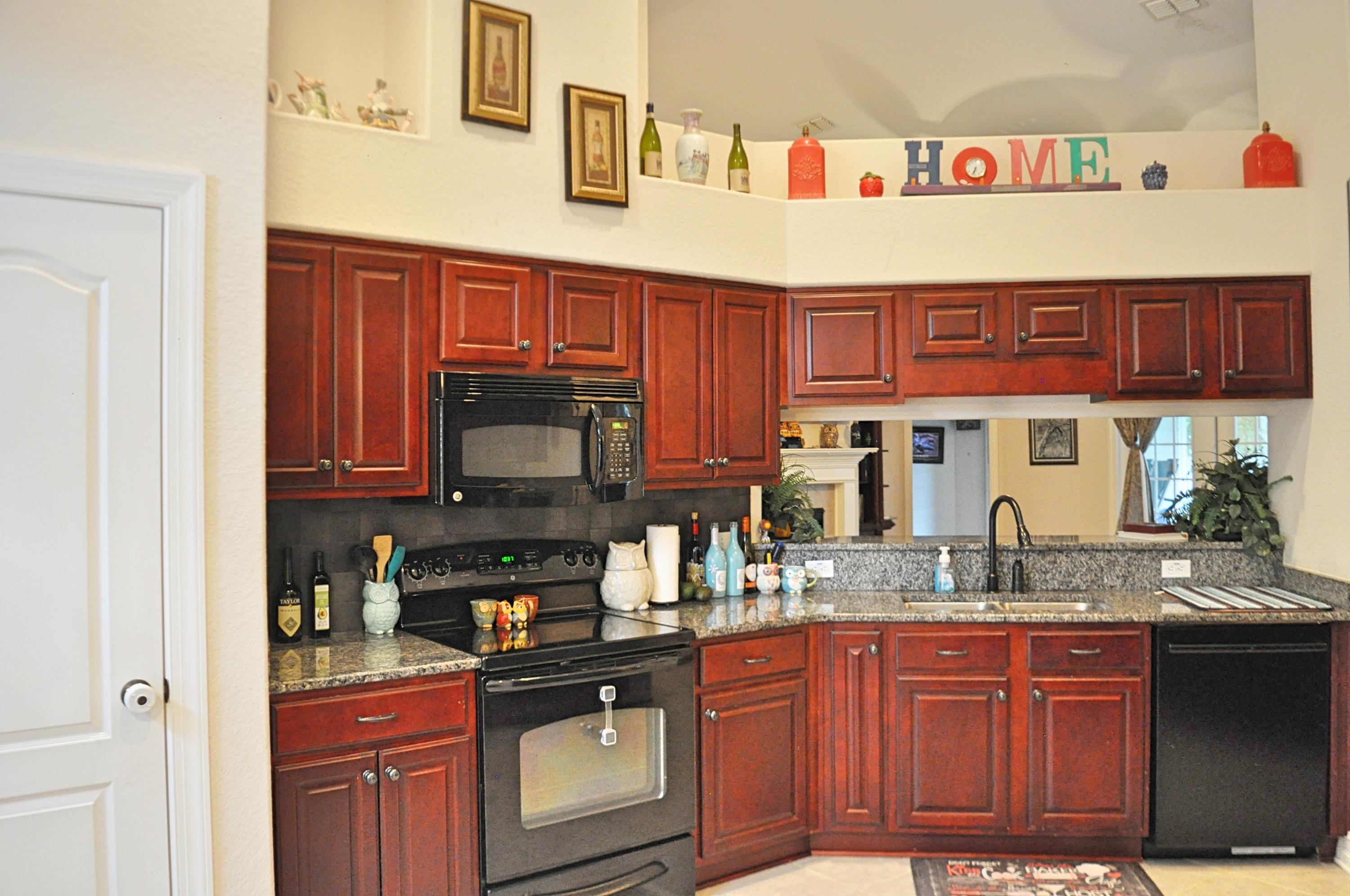 216 Mango Lane Freeport, FL 32439 - Photo 11 of 44 a kitchen with granite countertop a sink and cabinets