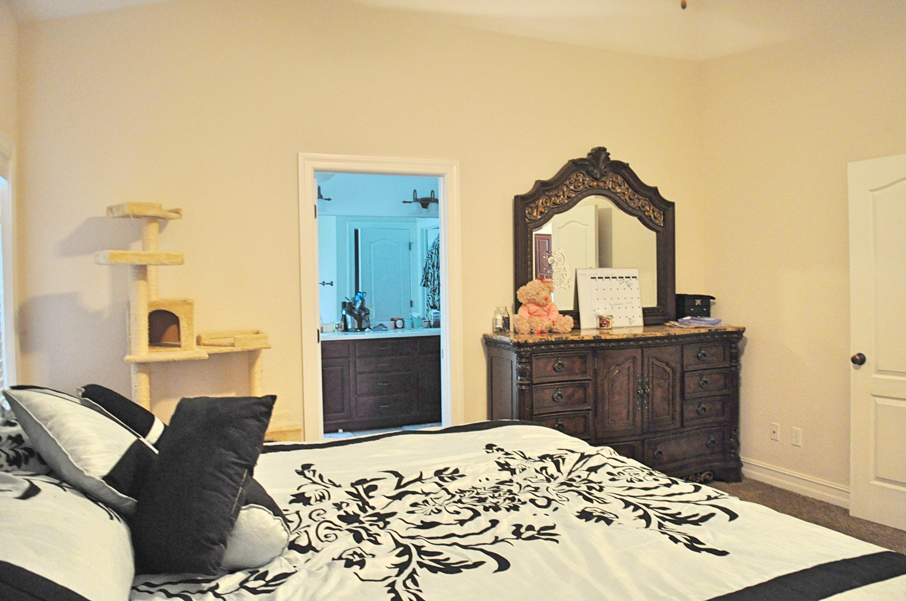 216 Mango Lane Freeport, FL 32439 - Photo 15 of 44 a bedroom with a bed and a dresser