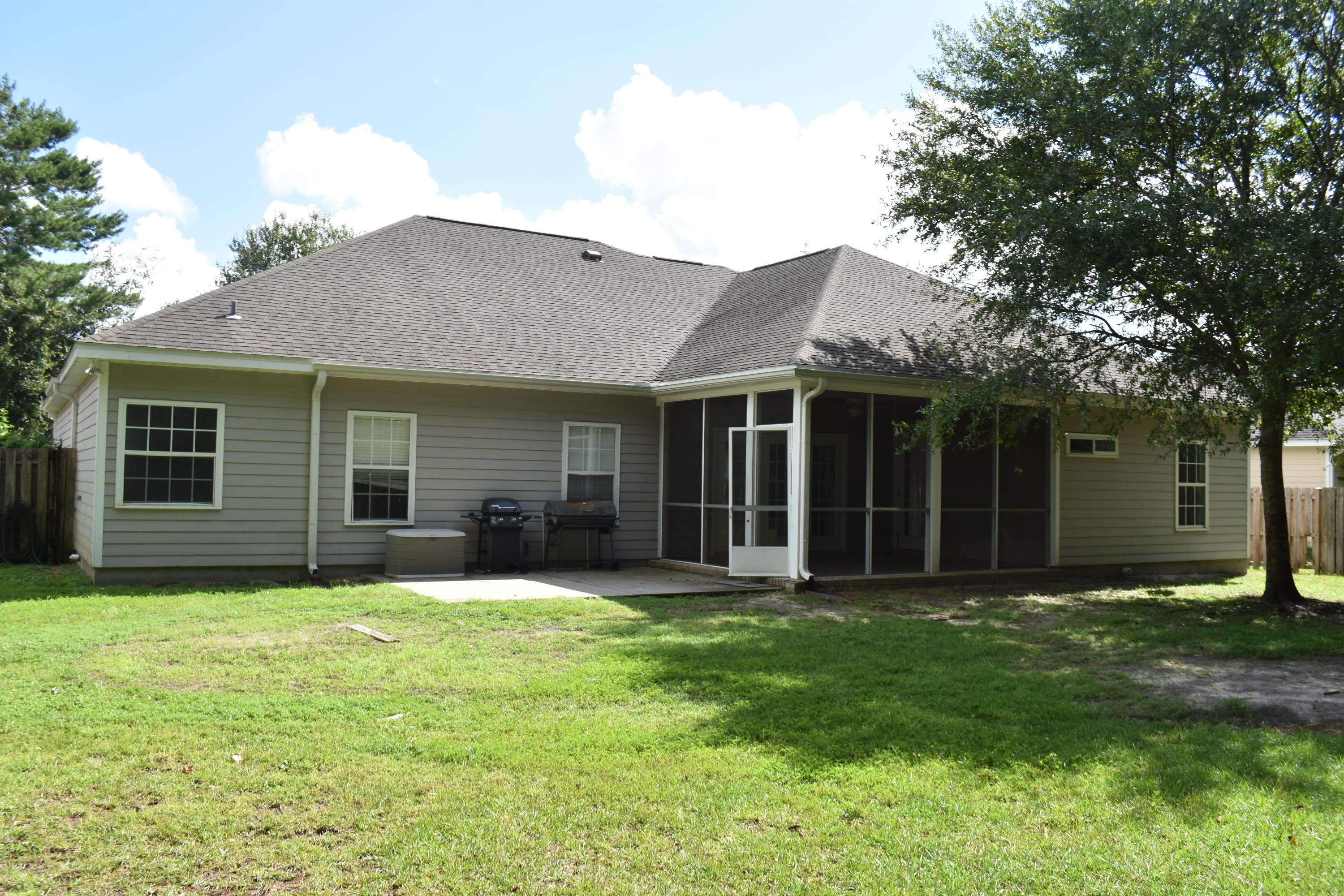 216 Mango Lane Freeport, FL 32439 - Photo 44 of 44 a brick house next to a yard with large trees