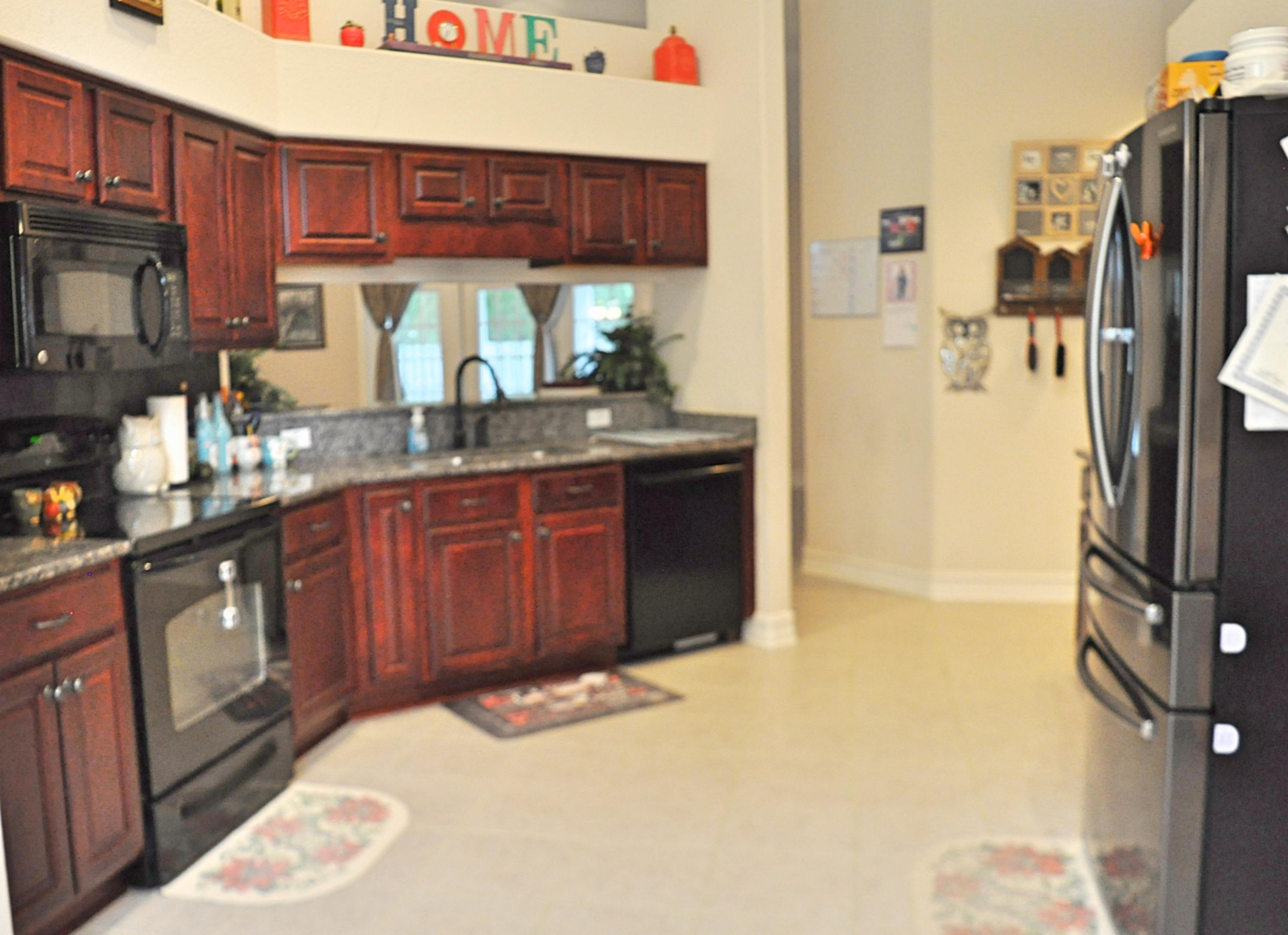 216 Mango Lane Freeport, FL 32439 - Photo 7 of 44 a kitchen with stainless steel appliances granite countertop a refrigerator a stove and a sink