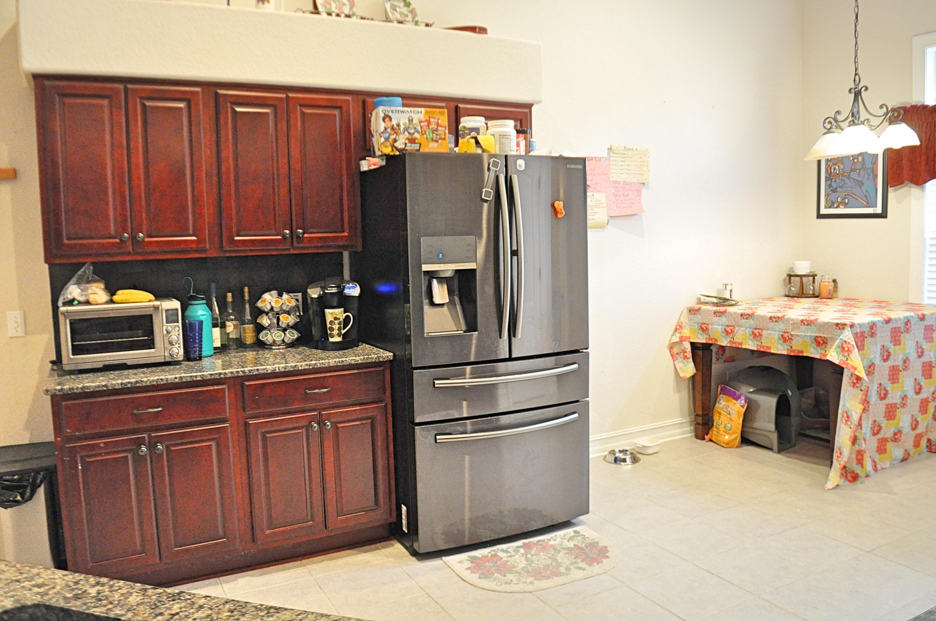 216 Mango Lane Freeport, FL 32439 - Photo 9 of 44 a kitchen with stainless steel appliances granite countertop a refrigerator a stove and a wooden cabinets