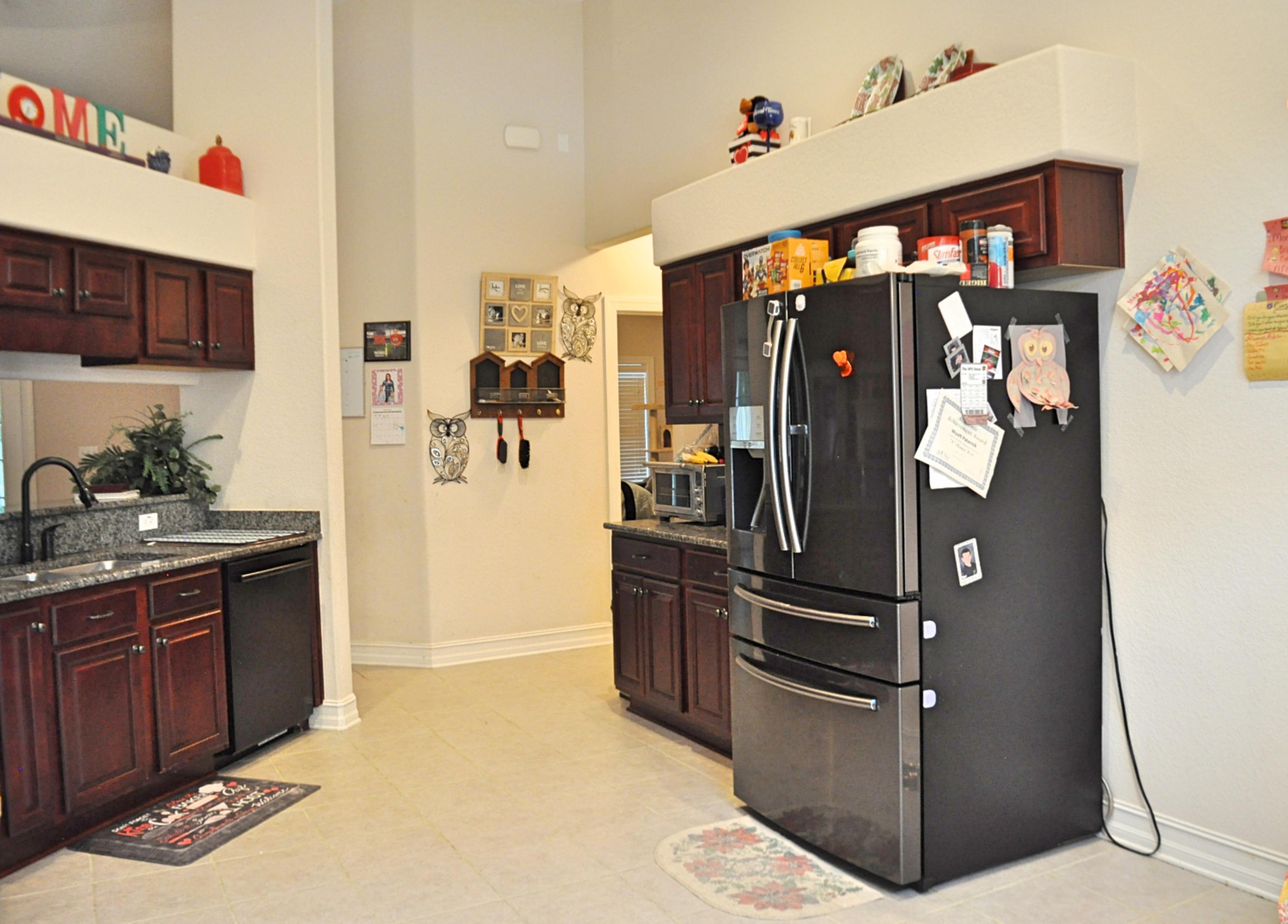 216 Mango Lane Freeport, FL 32439 - Photo 10 of 44 a kitchen with stainless steel appliances granite countertop a refrigerator and a sink