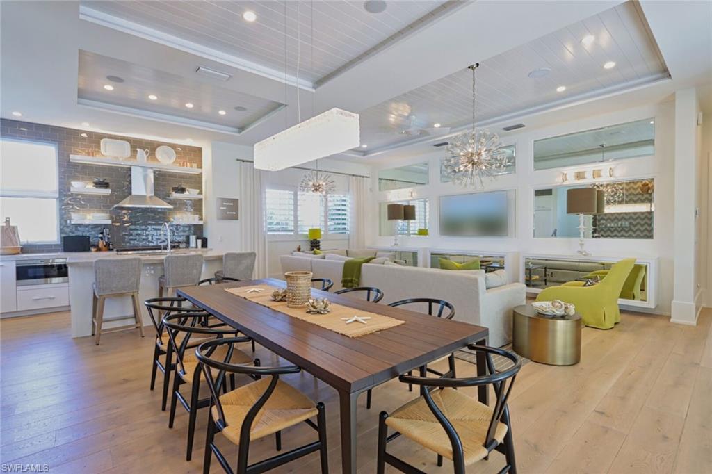 675 2nd Street South Naples, FL 34102 - Photo 6 of 41 a view of a dining area with furniture and wooden floor