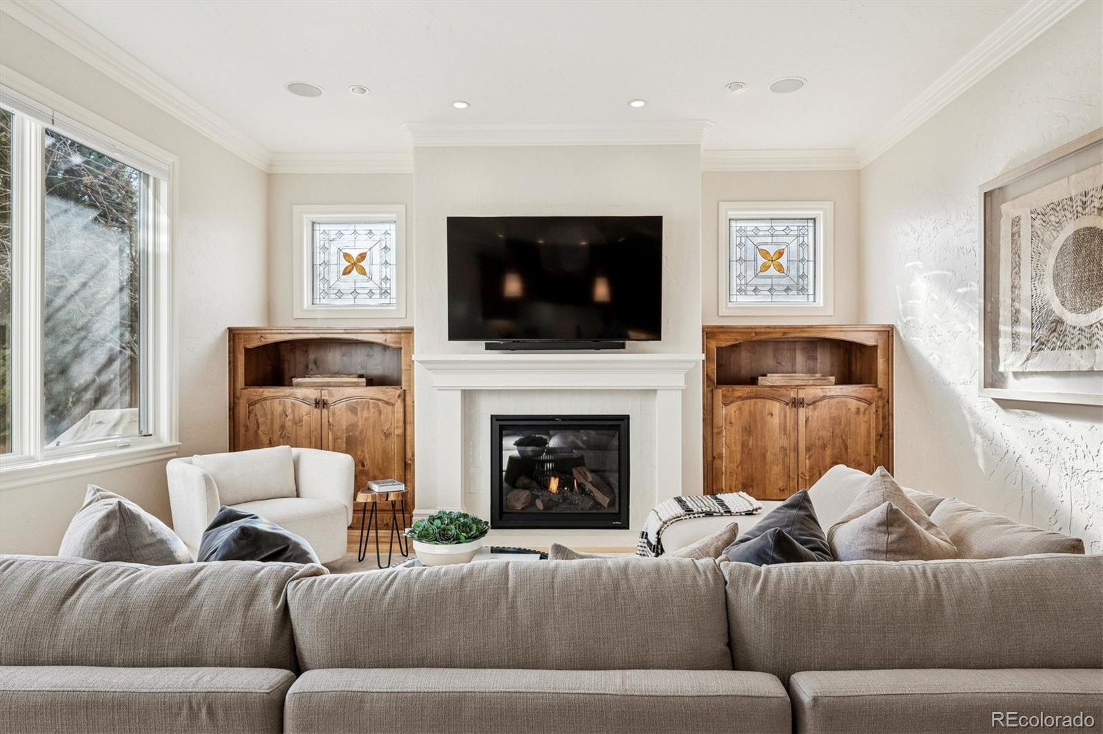 542 Adams Street Denver, CO 80206 - Photo 13 of 31 a living room with furniture a flat screen tv and a fireplace