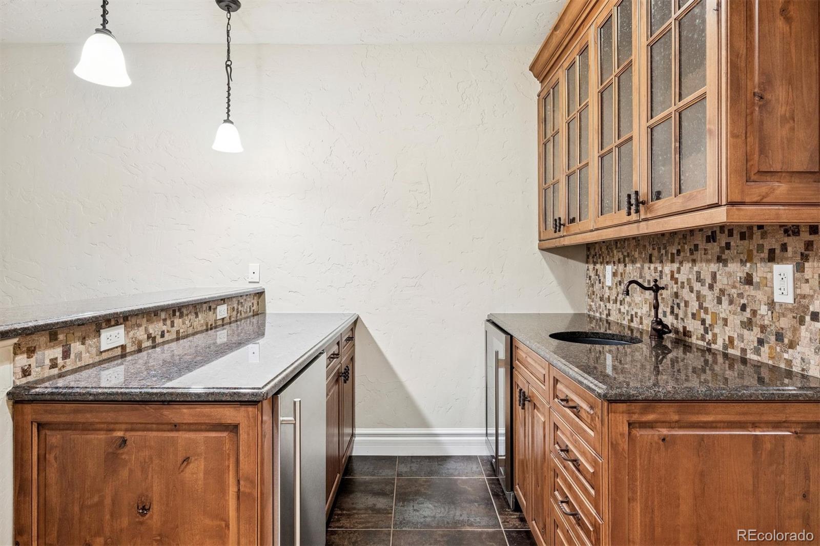542 Adams Street Denver, CO 80206 - Photo 21 of 31 a kitchen with stainless steel appliances granite countertop a sink and a granite counter tops with white countertops