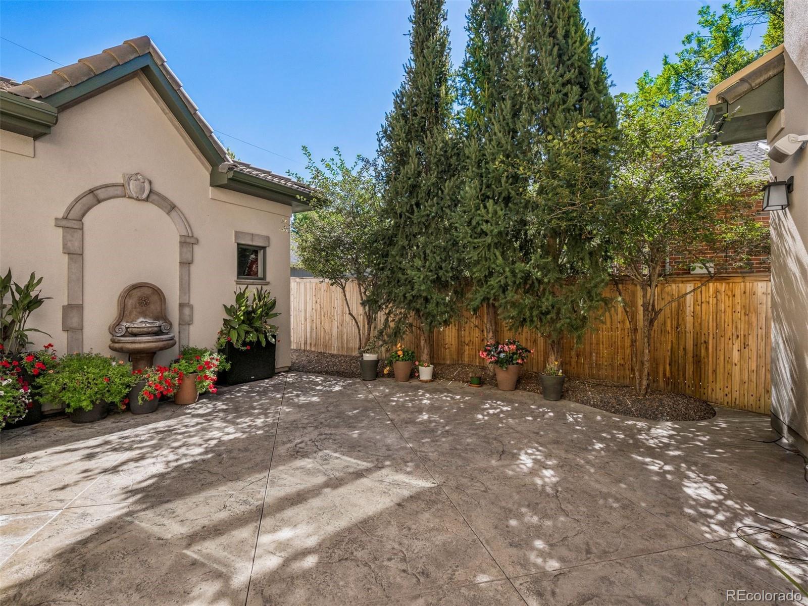 542 Adams Street Denver, CO 80206 - Photo 22 of 31 a view of a house with backyard and a tree