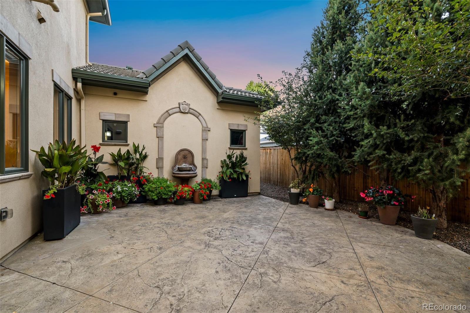 542 Adams Street Denver, CO 80206 - Photo 23 of 31 a view of a house with a small yard and a large tree