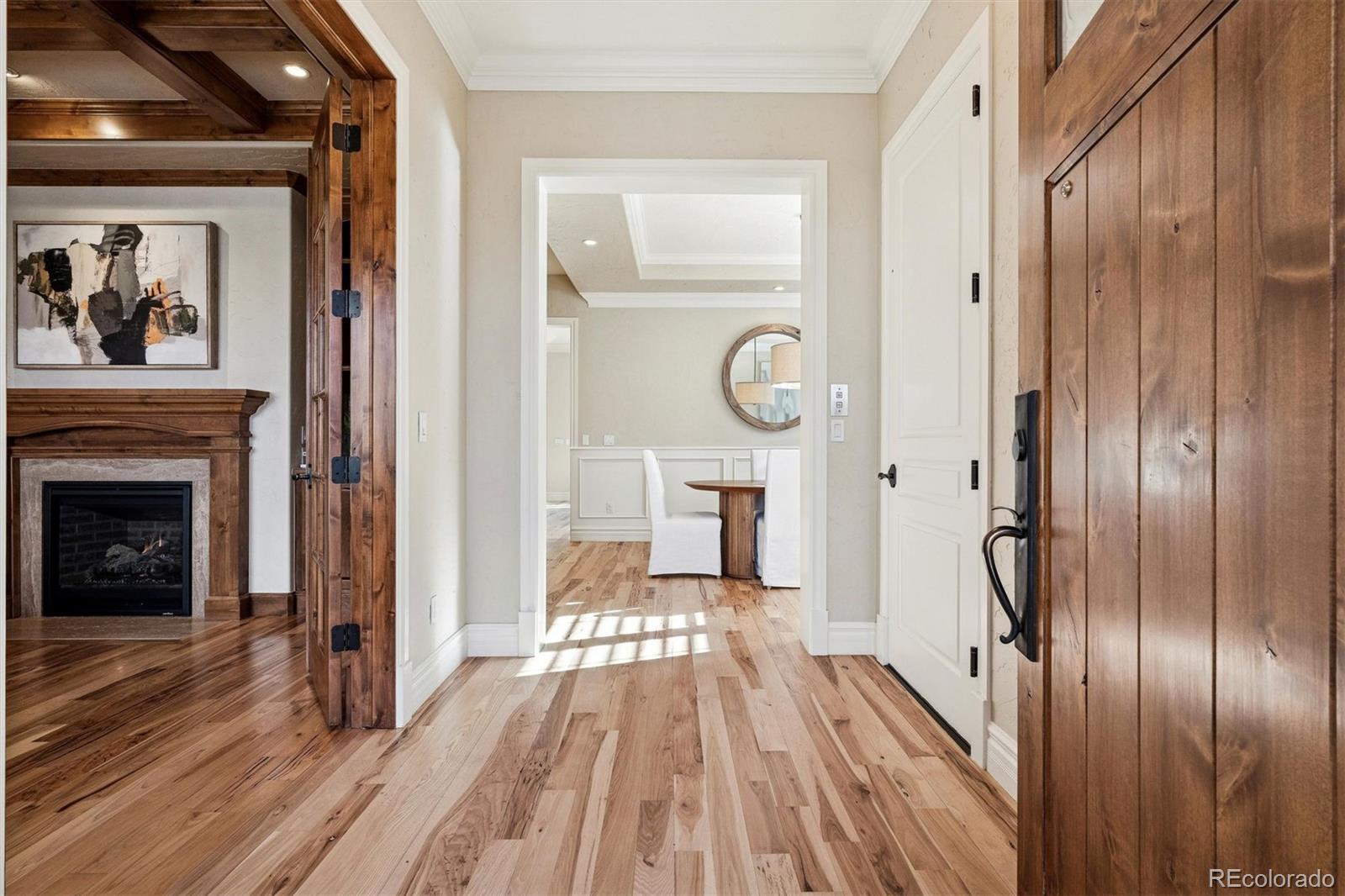 542 Adams Street Denver, CO 80206 - Photo 4 of 31 a view of a hallway with wooden floor and staircase
