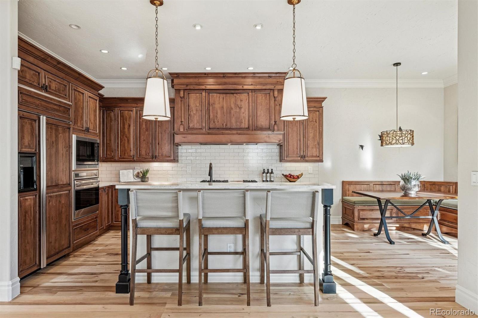 542 Adams Street Denver, CO 80206 - Photo 9 of 31 a kitchen with cabinets and chairs