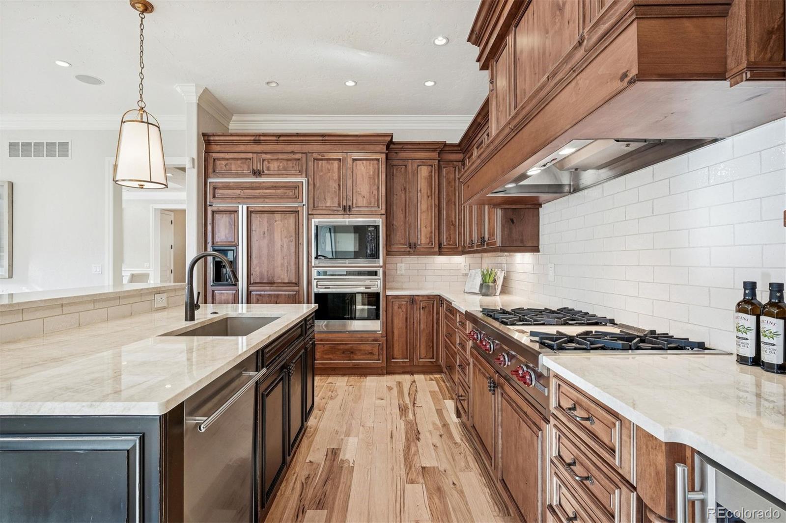 542 Adams Street Denver, CO 80206 - Photo 10 of 31 a kitchen with stainless steel appliances granite countertop a sink stove and cabinets