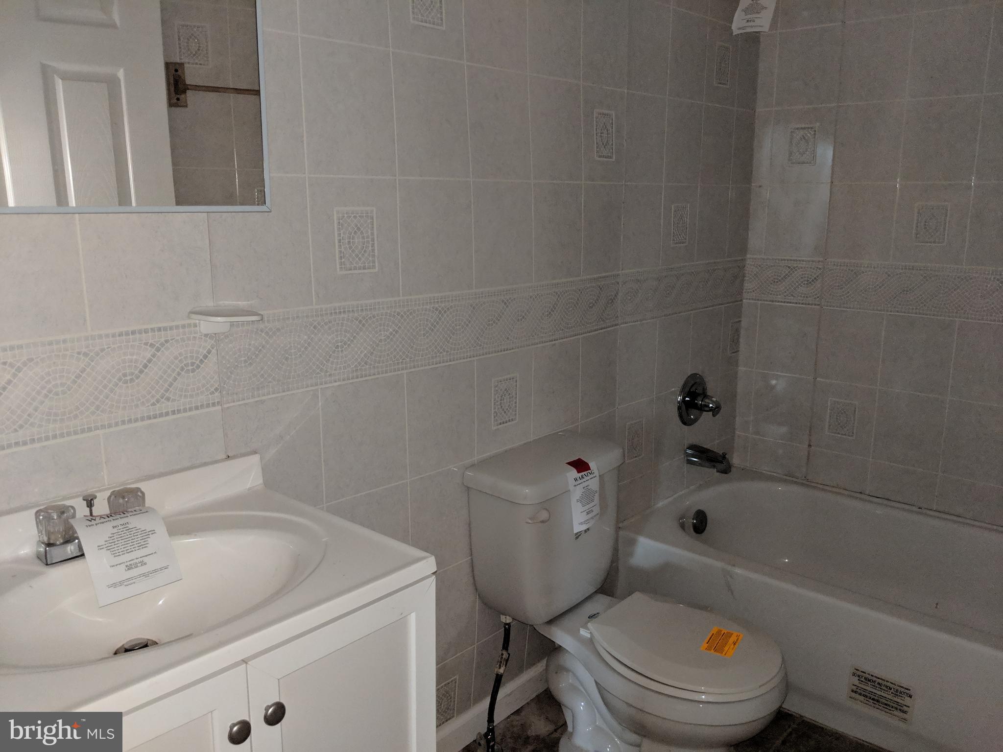 770 Elmhurst Road Severn, MD 21144 - Photo 14 of 26 a bathroom with a sink toilet and bathtub