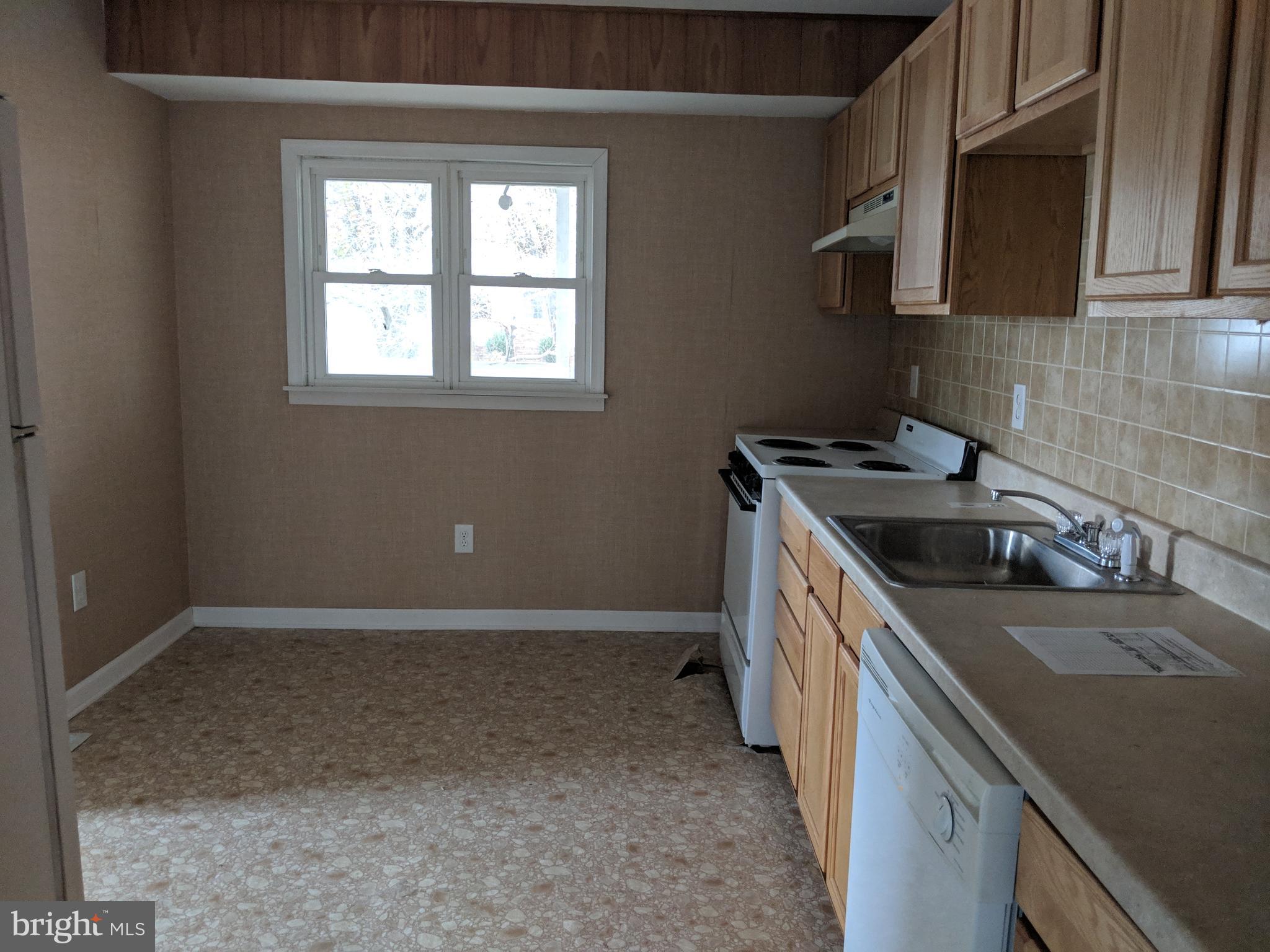770 Elmhurst Road Severn, MD 21144 - Photo 17 of 26 a kitchen that has a sink and a stove