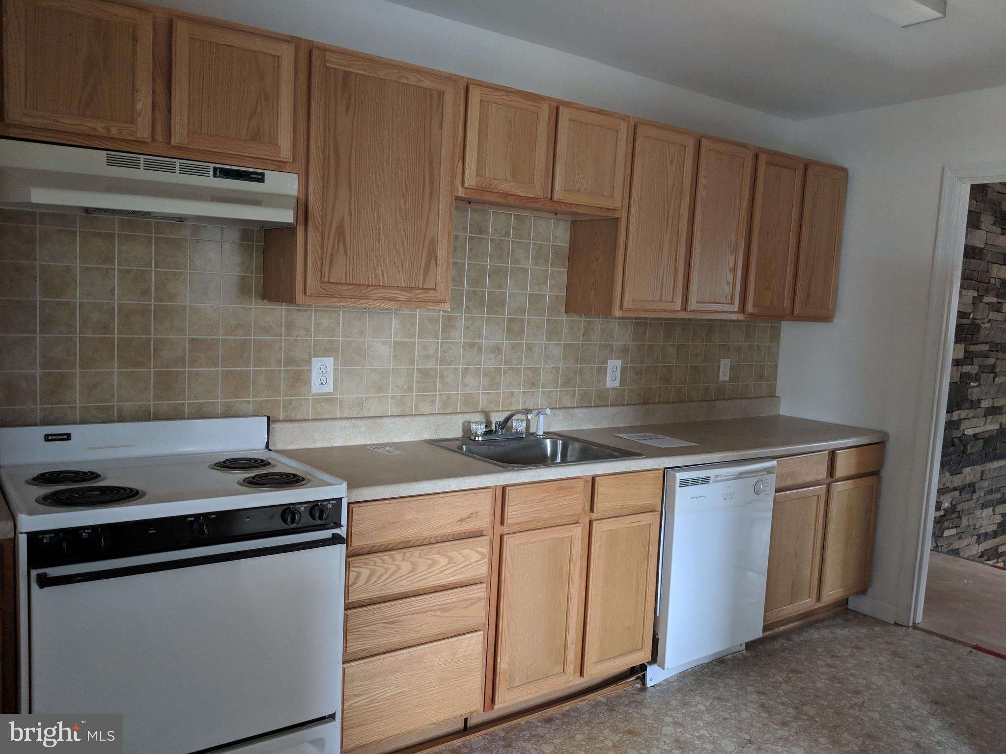 770 Elmhurst Road Severn, MD 21144 - Photo 18 of 26 a kitchen with stainless steel appliances granite countertop a sink stove and cabinets
