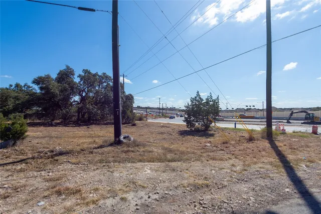 a view of dirt yard with a tree