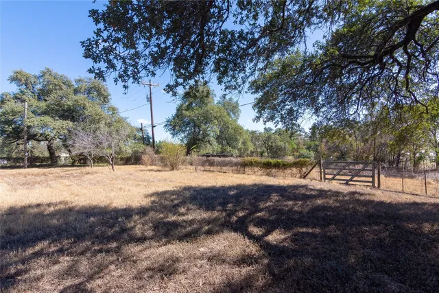 a view of a house with yard and sitting area