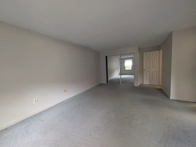 a view of empty room with window and fireplace