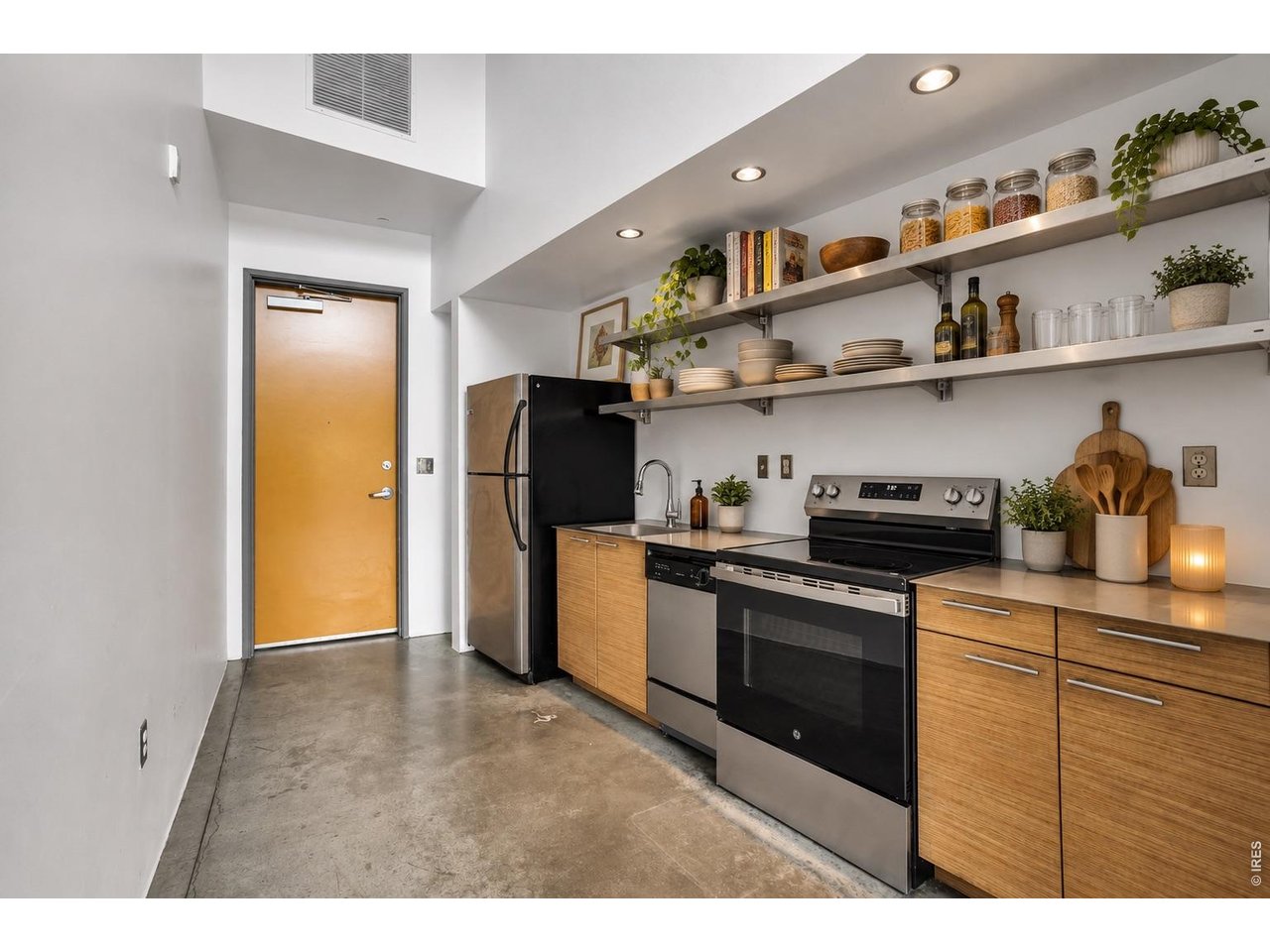 3457 Ringsby Court, Unit 327 Denver, CO 80216 - Photo 5 of 29 Kitchen with new Stove and Disposal