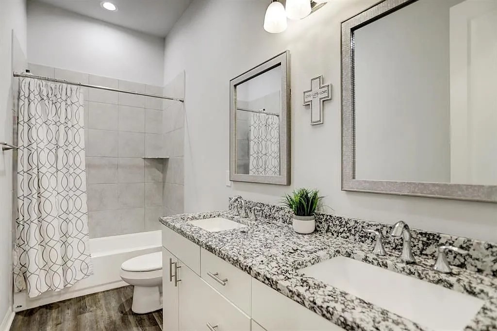 4906 Paradigm Ln Spring Spring, TX 77379 - Photo 11 of 17 a bathroom with a granite countertop sink a toilet and shower