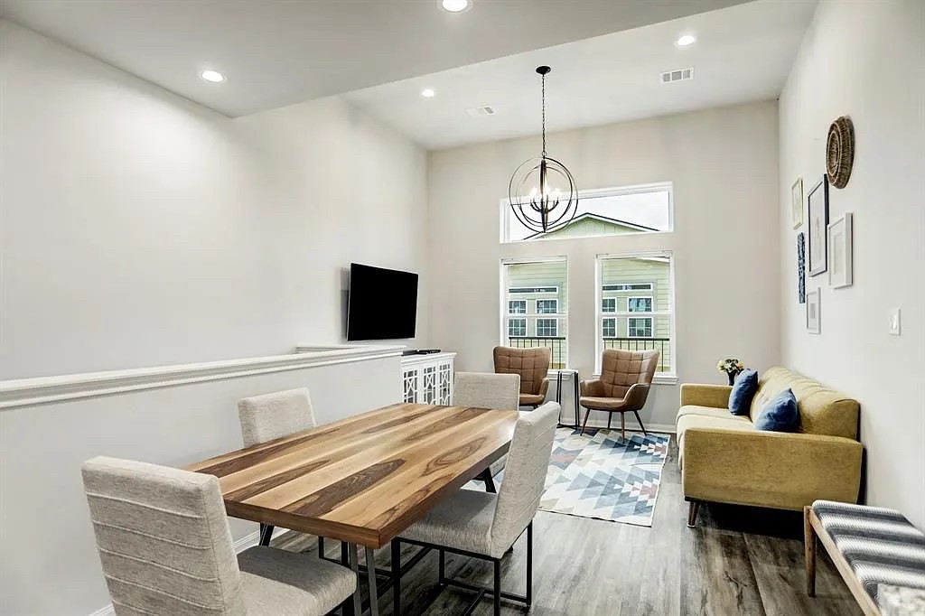 4906 Paradigm Ln Spring Spring, TX 77379 - Photo 2 of 17 a living room with furniture a flat screen tv and wooden floor
