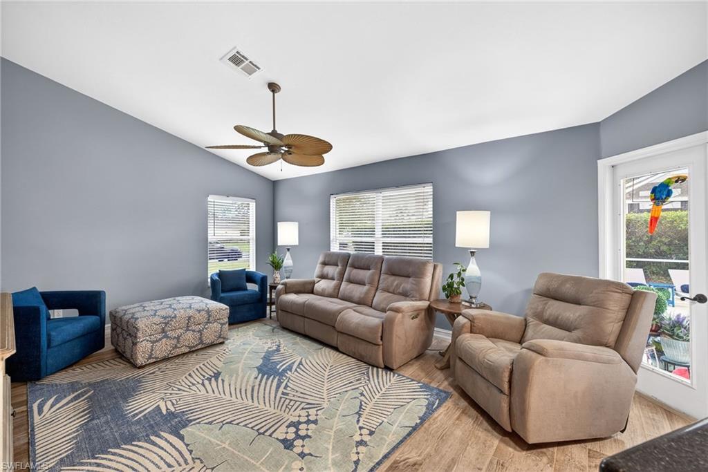 390 St Andrews Boulevard Naples, FL 34113 - Photo 12 of 42 Living room with lofted ceiling, light wood-type flooring, and a ceiling fan