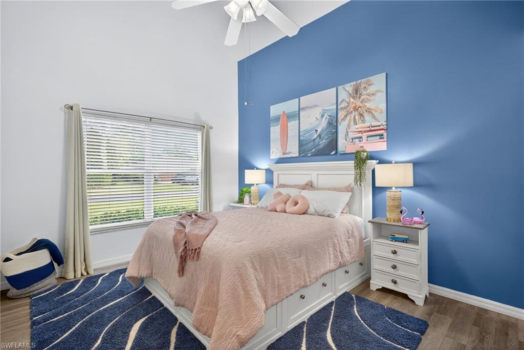 390 St Andrews Boulevard Naples, FL 34113 - Photo 21 of 42 Bedroom featuring dark wood-style floors, ceiling fan, and a high ceiling