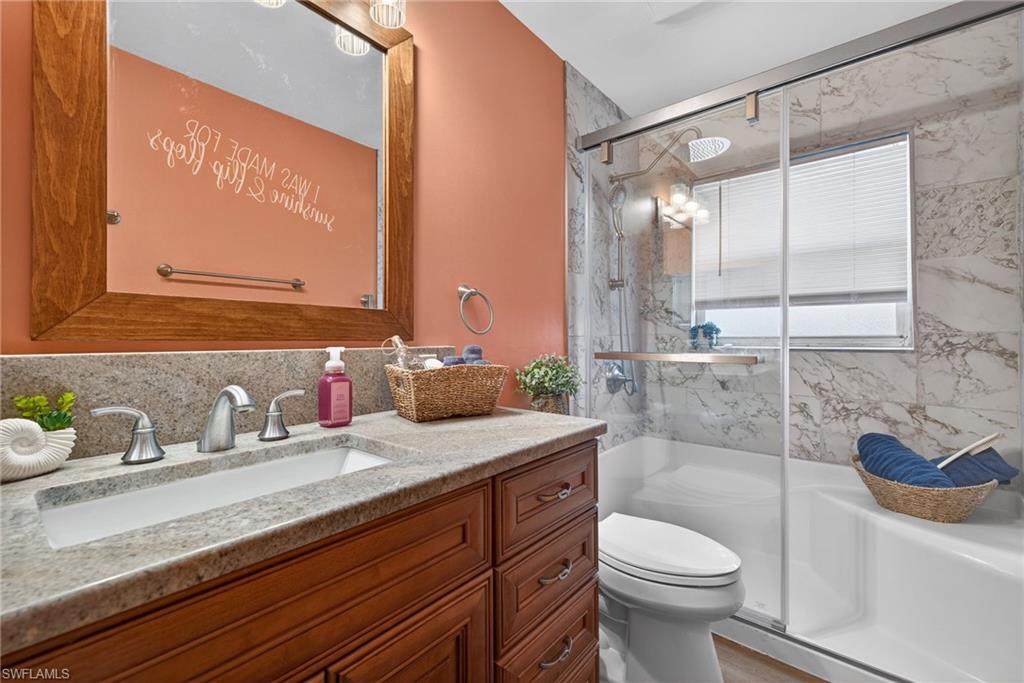 390 St Andrews Boulevard Naples, FL 34113 - Photo 22 of 42 Full bathroom with vanity and a marble finish shower