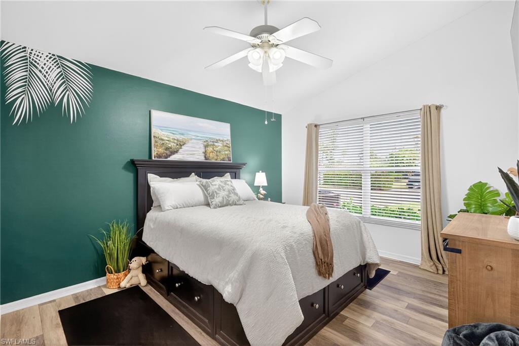 390 St Andrews Boulevard Naples, FL 34113 - Photo 23 of 42 Bedroom featuring light wood-style flooring, vaulted ceiling, and a ceiling fan