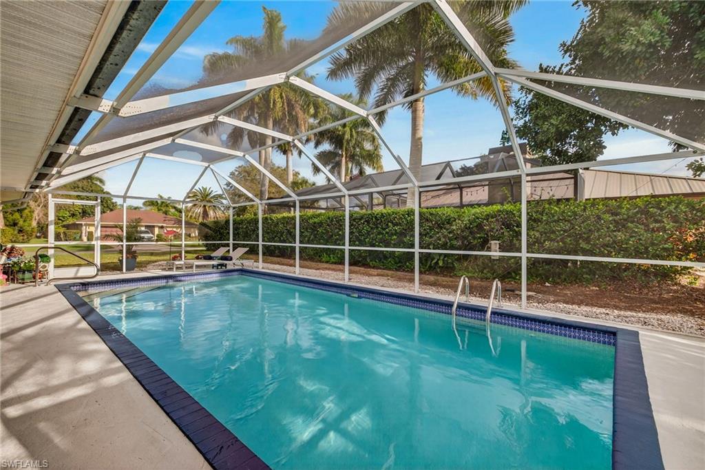390 St Andrews Boulevard Naples, FL 34113 - Photo 26 of 42 View of swimming pool with screen enclosure