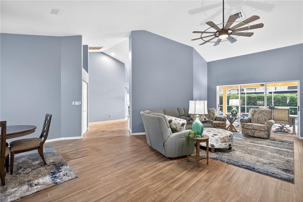 390 St Andrews Boulevard Naples, FL 34113 - Photo 5 of 42 Living area featuring ceiling fan, light wood finished floors