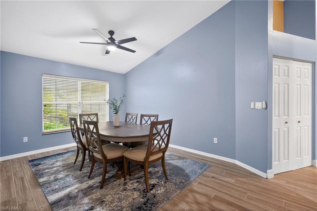 390 St Andrews Boulevard Naples, FL 34113 - Photo 8 of 42 Dining area featuring lofted ceiling, ceiling fan, and light wood-type flooring