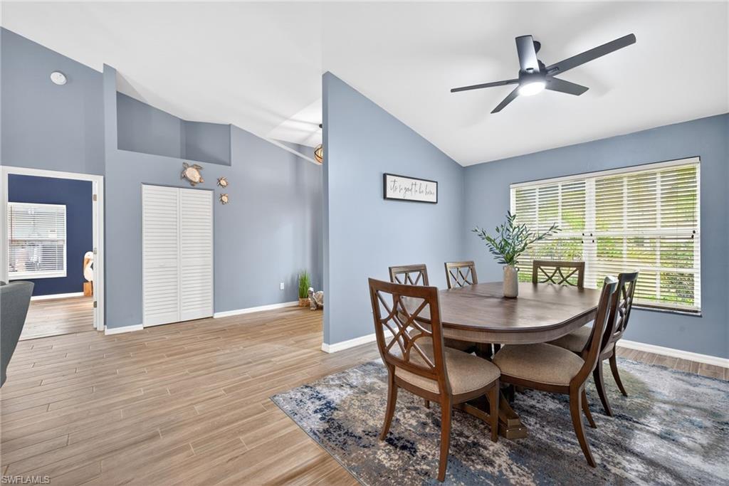 390 St Andrews Boulevard Naples, FL 34113 - Photo 9 of 42 Dining room featuring wood-style flooring, and a ceiling fan