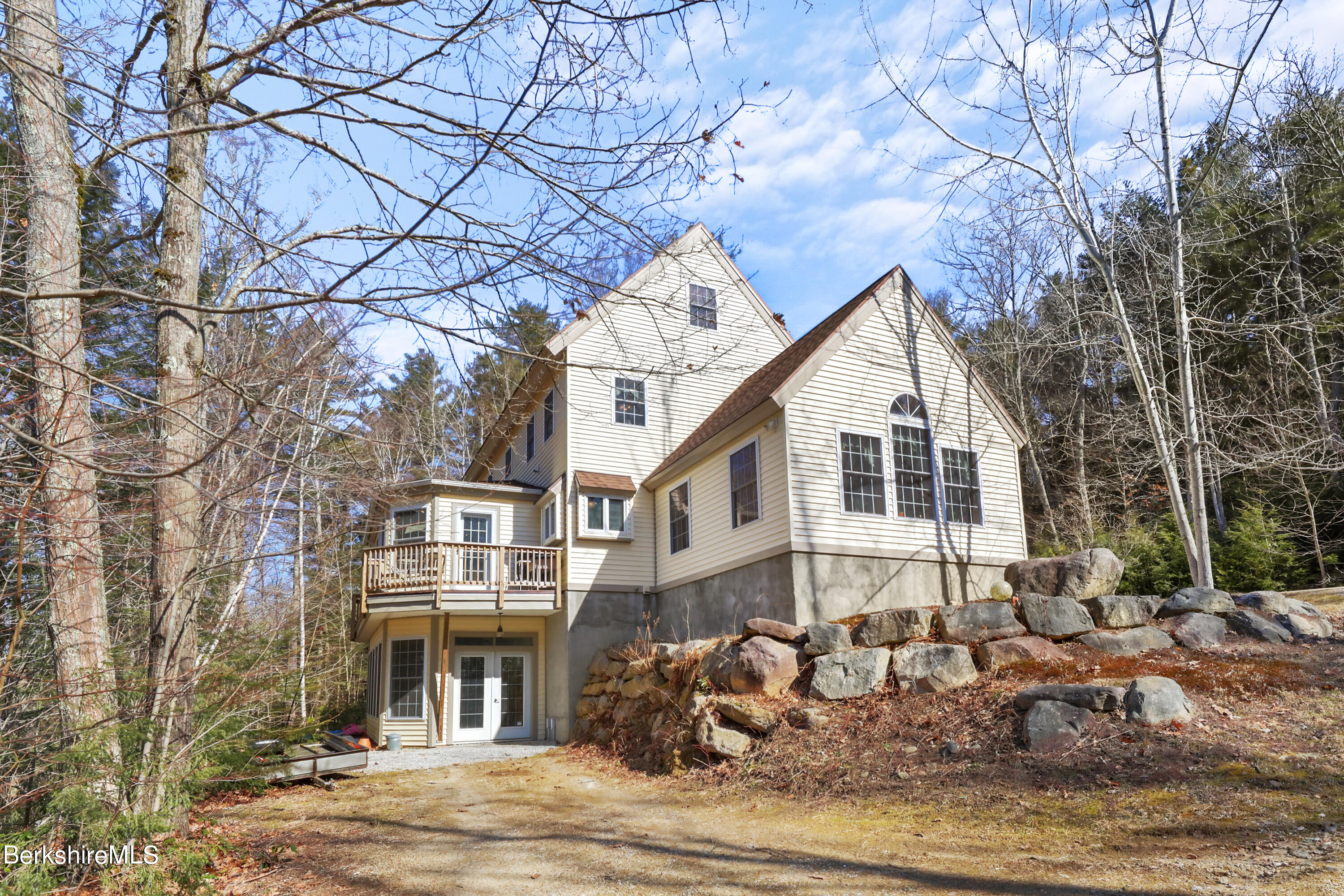 20 Ray Hubbard Road Otis, MA 01029 - Photo 1 of 59 a front view of a house with a yard and trees