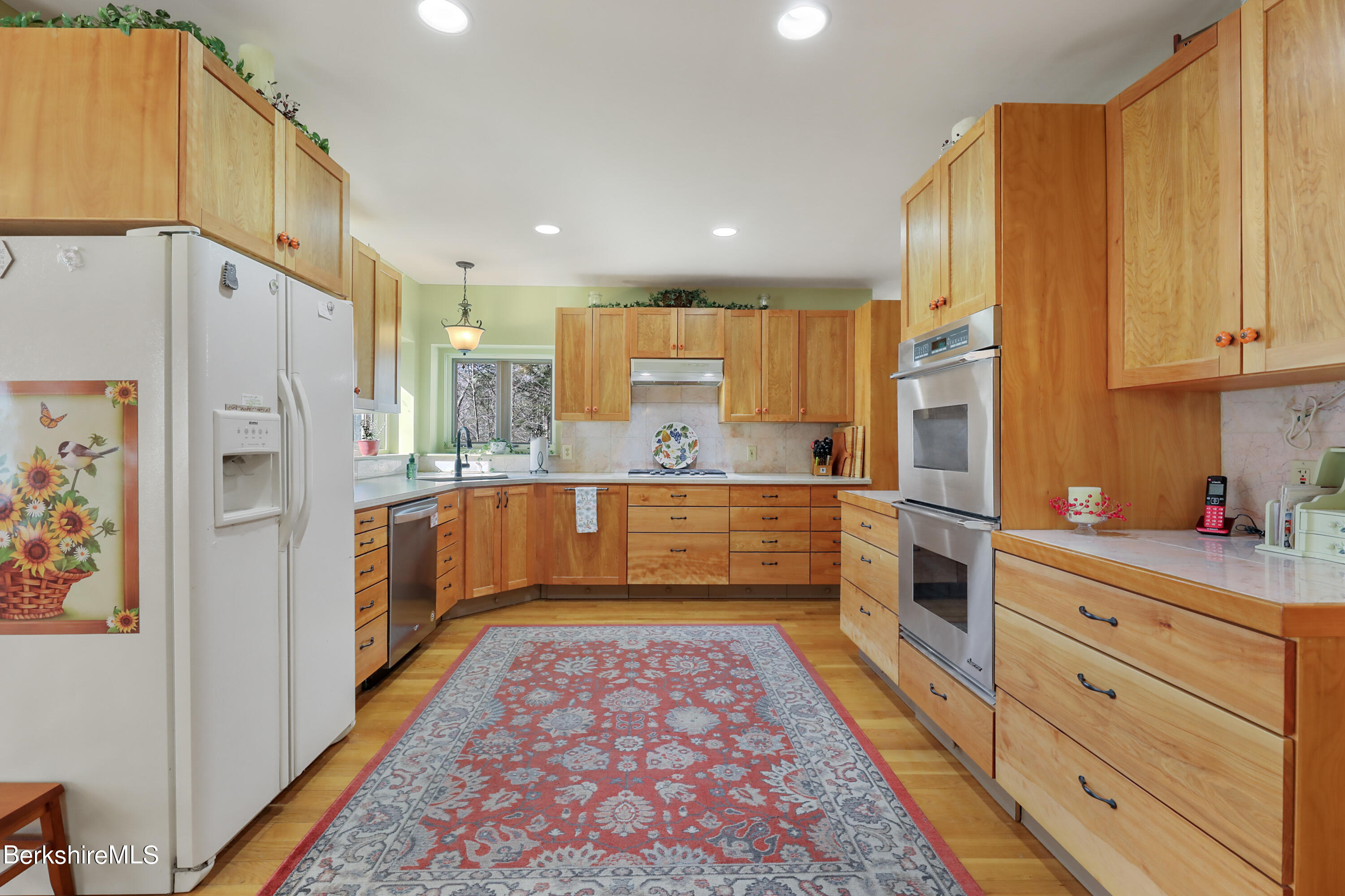 20 Ray Hubbard Road Otis, MA 01029 - Photo 19 of 59 a kitchen with stainless steel appliances kitchen island granite countertop a refrigerator and cabinets