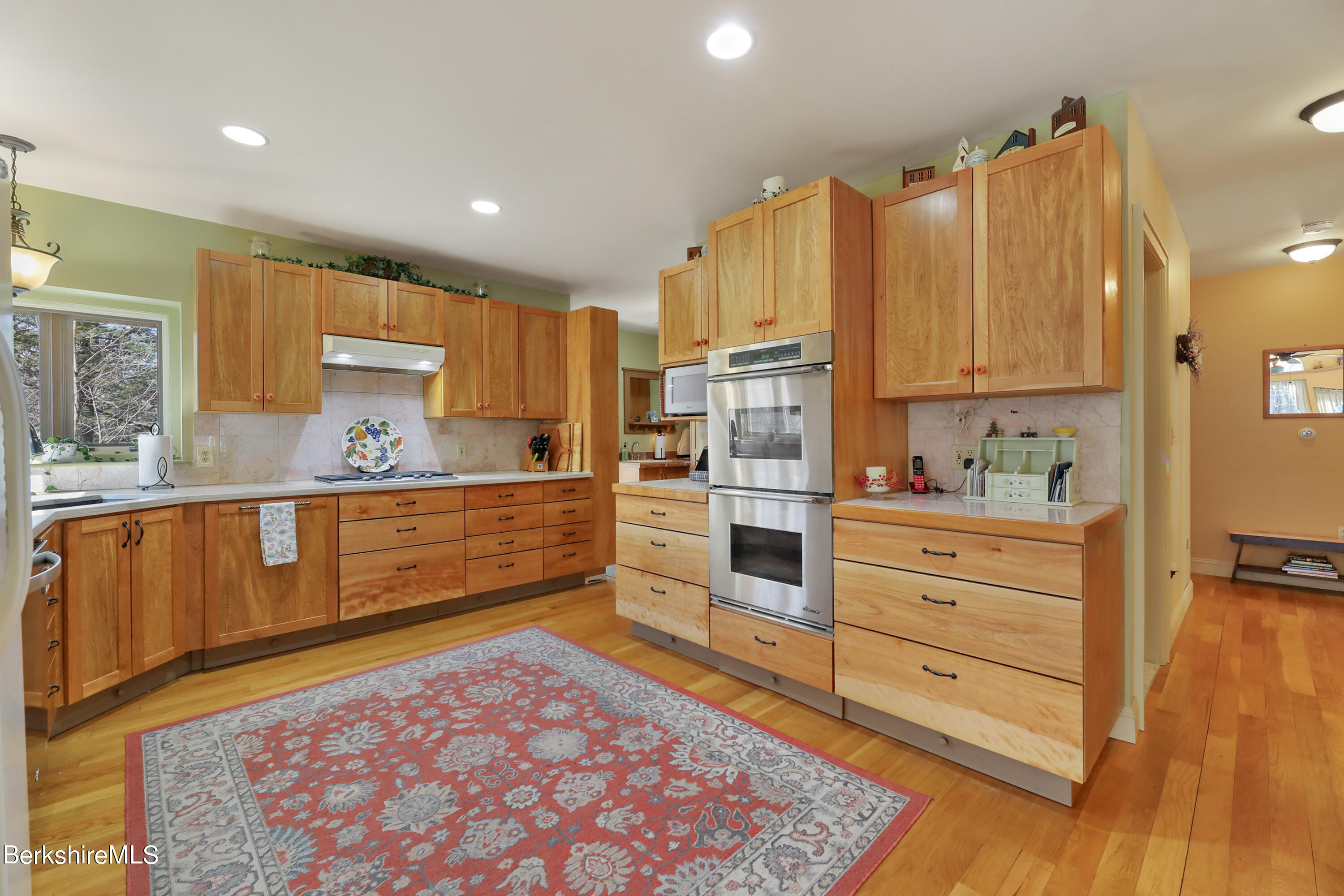 20 Ray Hubbard Road Otis, MA 01029 - Photo 20 of 59 a kitchen with stainless steel appliances kitchen island granite countertop a refrigerator and cabinets