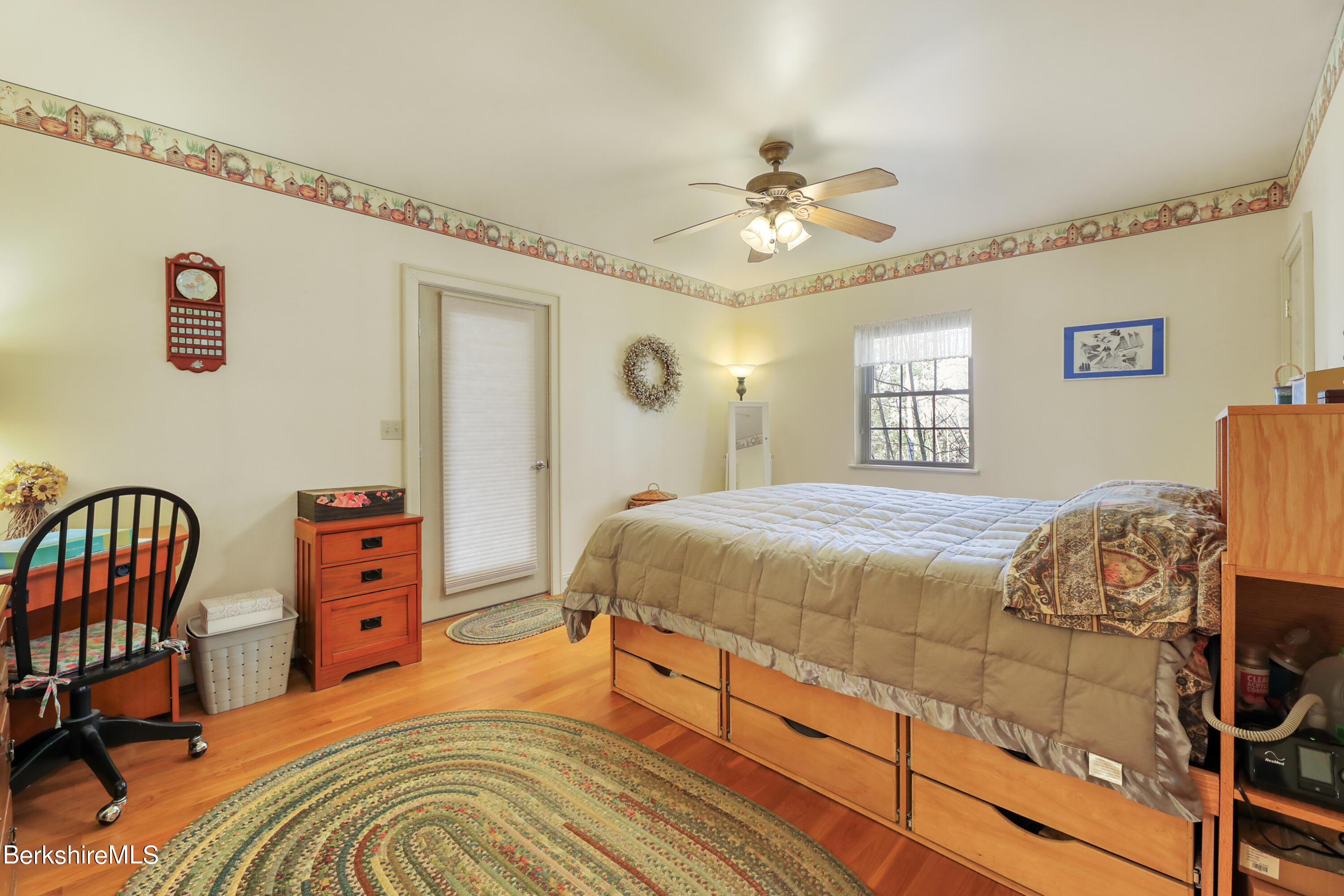 20 Ray Hubbard Road Otis, MA 01029 - Photo 29 of 59 a bedroom with a bed and a chandelier