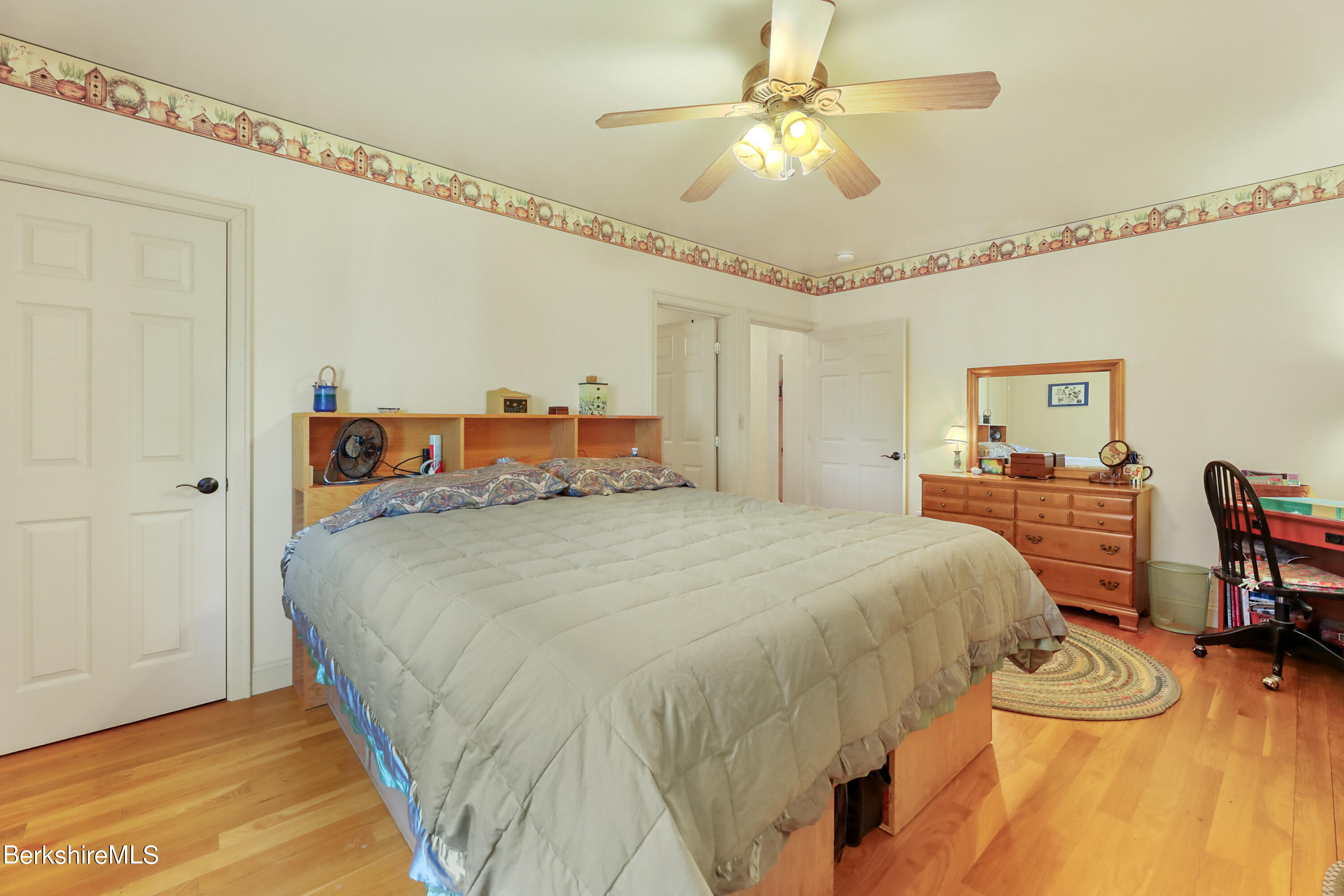 20 Ray Hubbard Road Otis, MA 01029 - Photo 30 of 59 a bedroom with a bed and a chandelier
