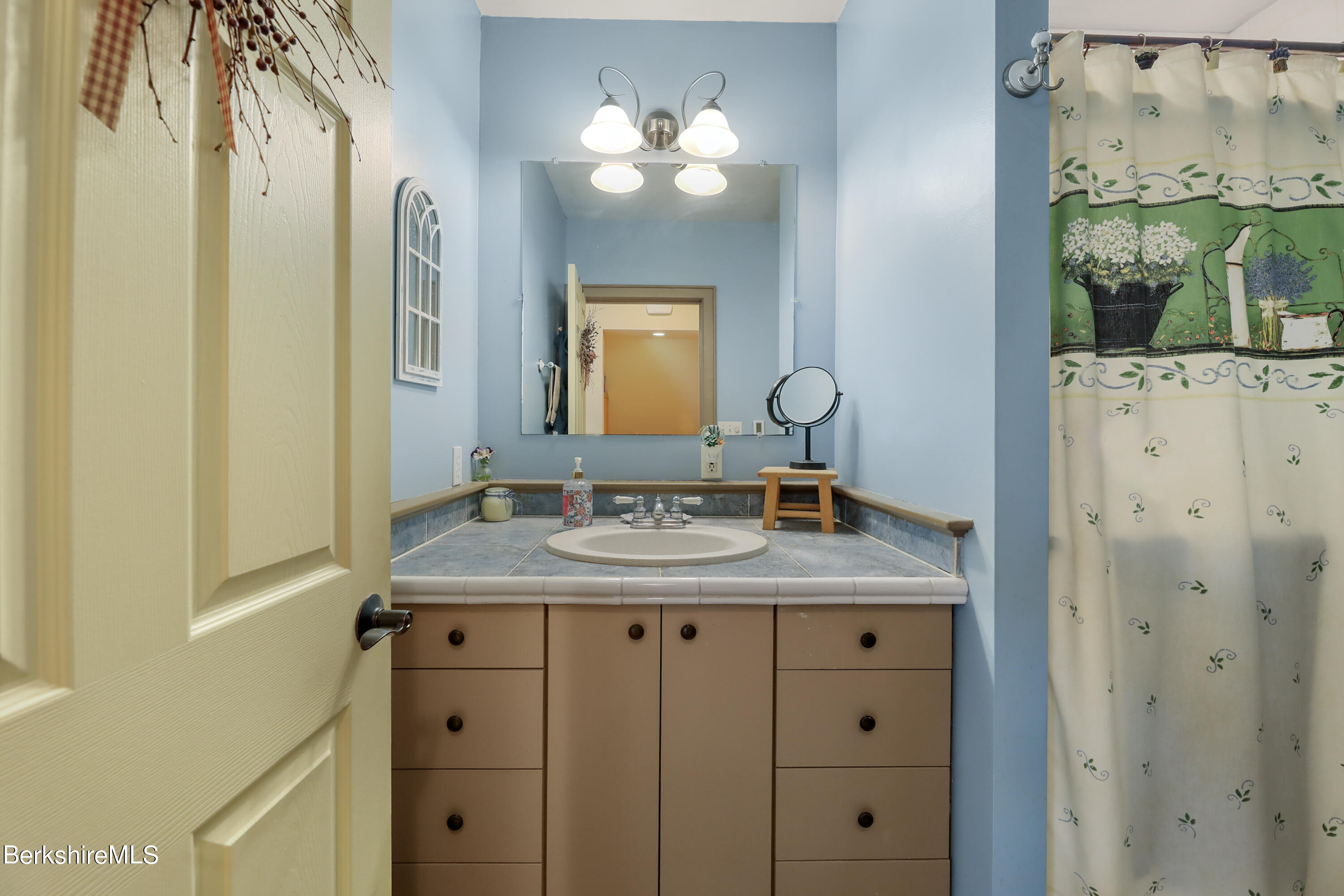 20 Ray Hubbard Road Otis, MA 01029 - Photo 34 of 59 a bathroom with a granite countertop sink a light fixture and a mirror