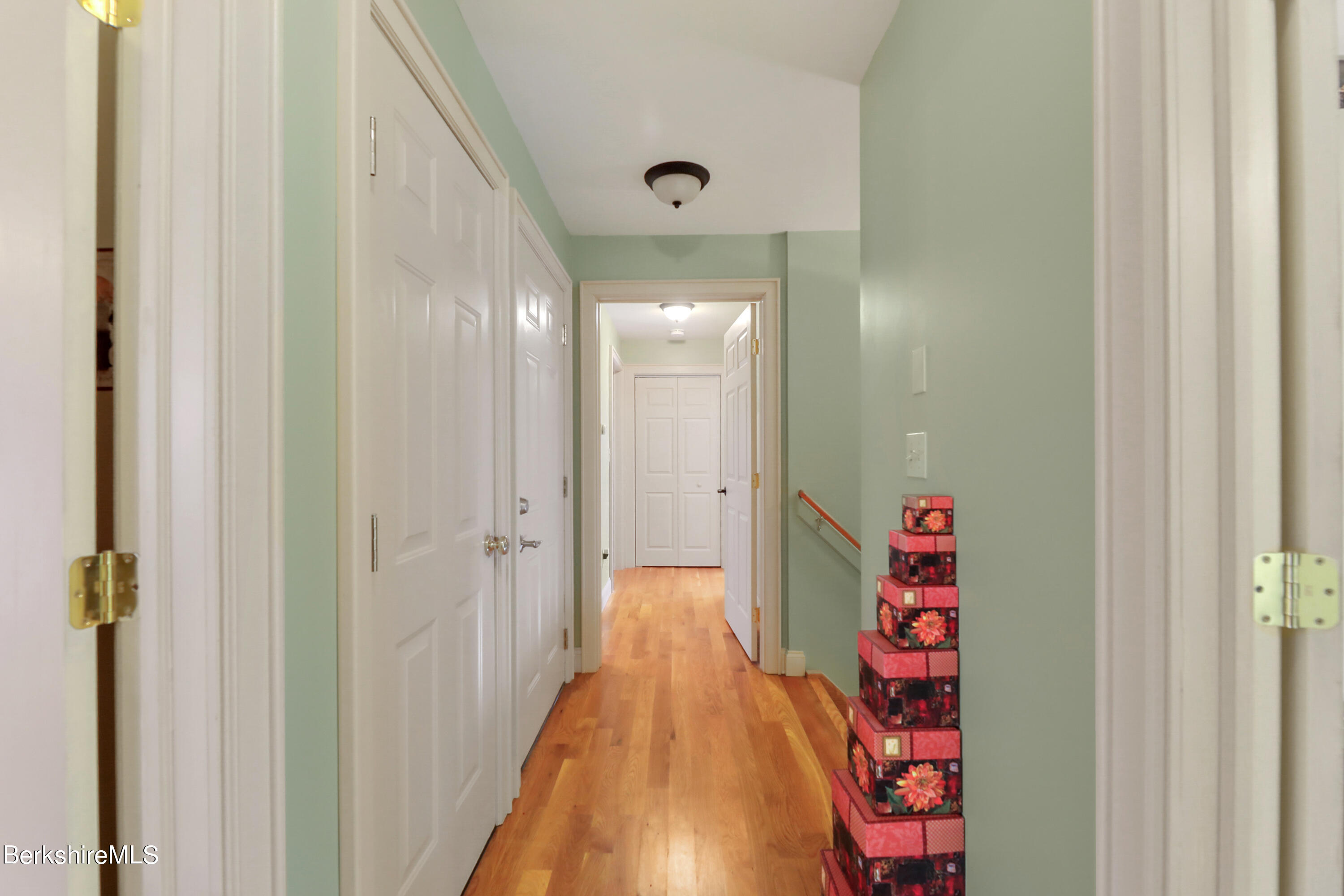 20 Ray Hubbard Road Otis, MA 01029 - Photo 35 of 59 a hallway with white cabinets and wooden floor