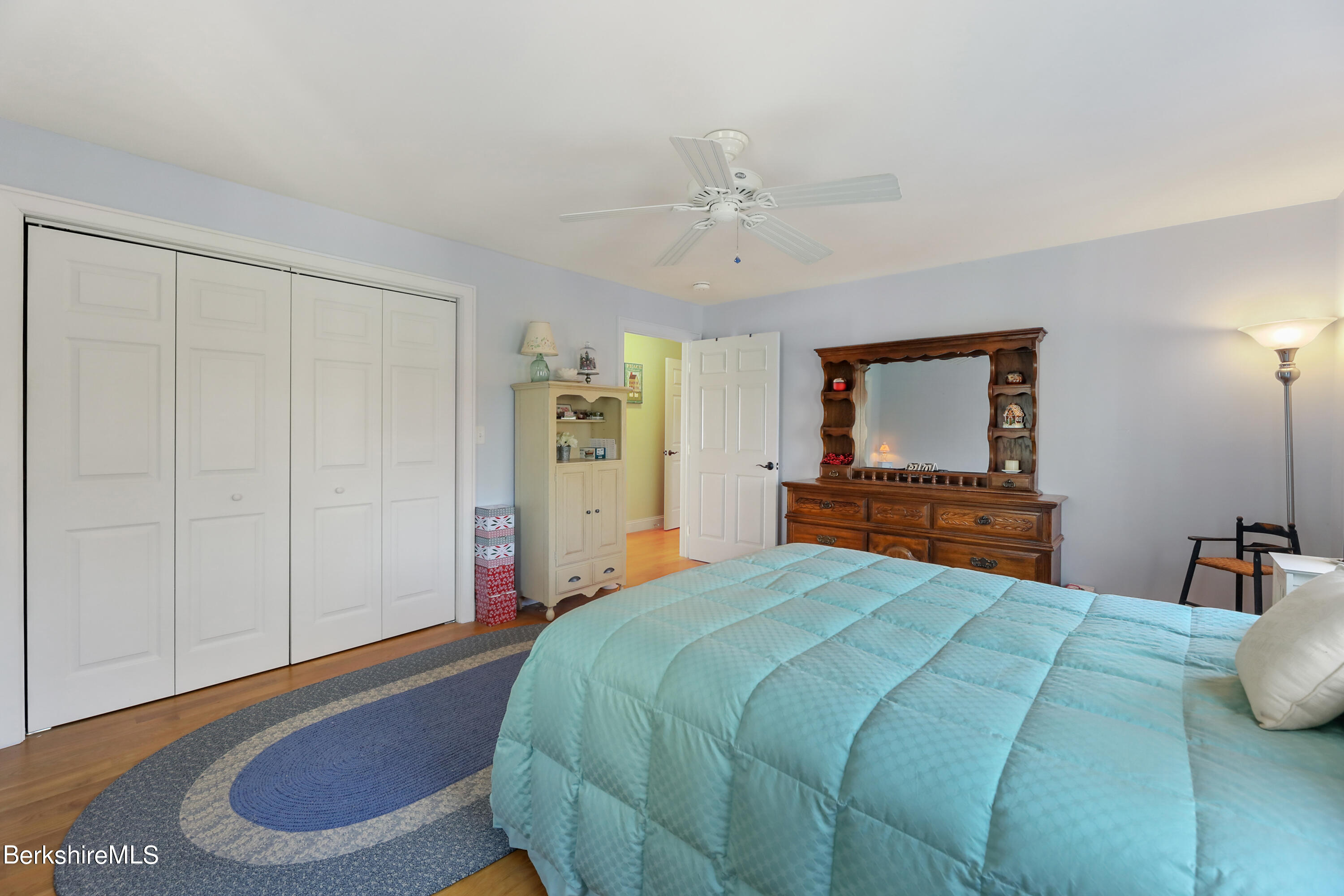 20 Ray Hubbard Road Otis, MA 01029 - Photo 37 of 59 a bedroom with a large bed and a chandelier