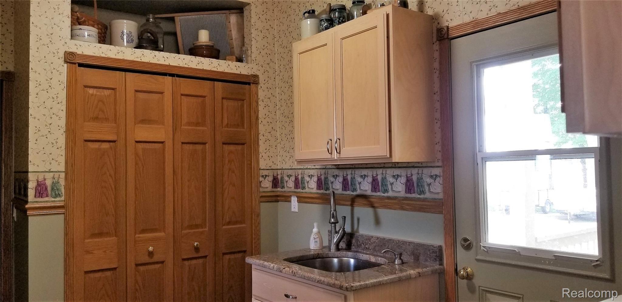 5800 Milett Road Fowlerville, MI 48836 - Photo 16 of 52 Laundry Room with Closet and Sink